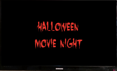 Halloween movie night - photo of a television set with those words in a horror font in orange on the screen